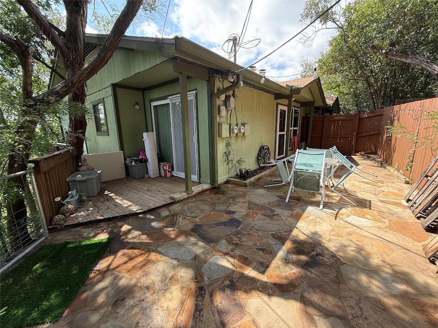 Rear view of property featuring a fenced backyard