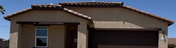View of front of home featuring a tile roof, stucc