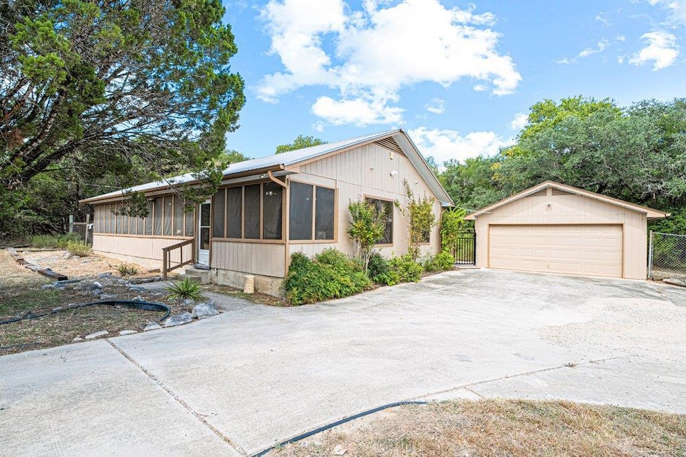 View of front of property featuring a sunroom, an