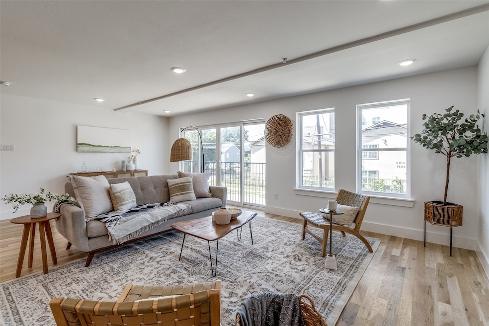 Living area featuring plenty of natural light, light wood-style floors, and recessed lighting
