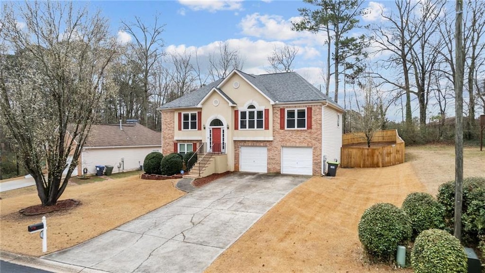 Split foyer home with a garage, driveway, a shingl
