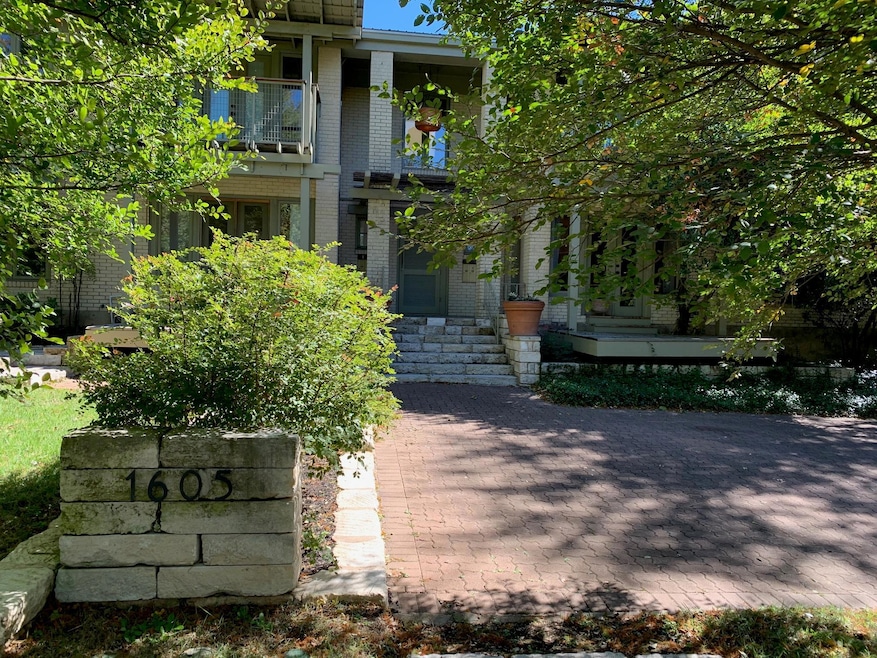 Property entrance with a balcony, cooling unit, a
