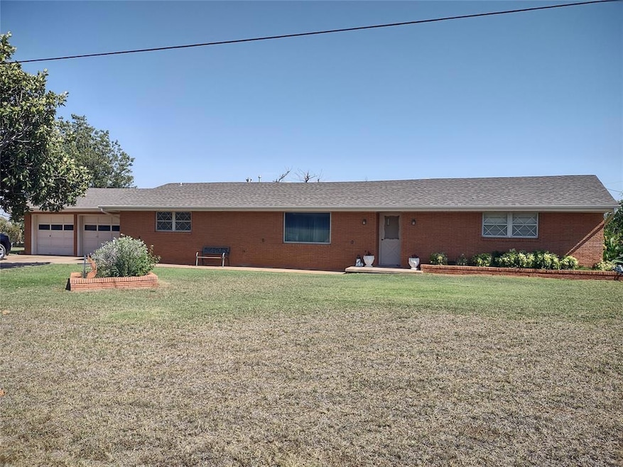 Ranch-style home with a garage and a front yard