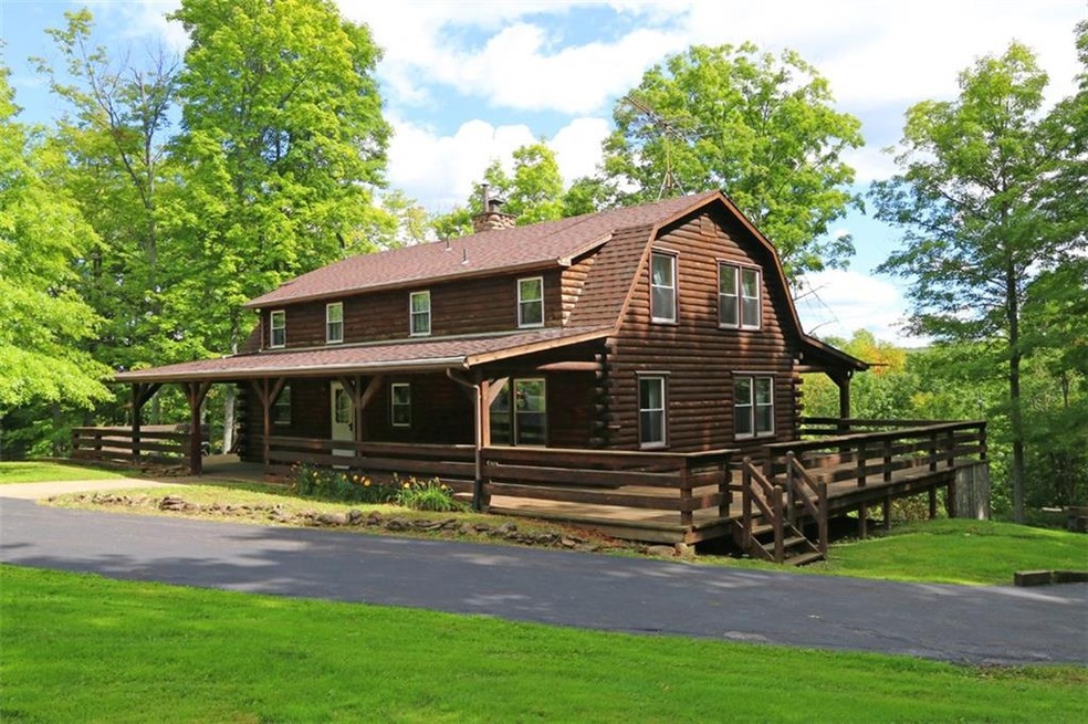 Log Cabin with full wrap around porch, covered fro