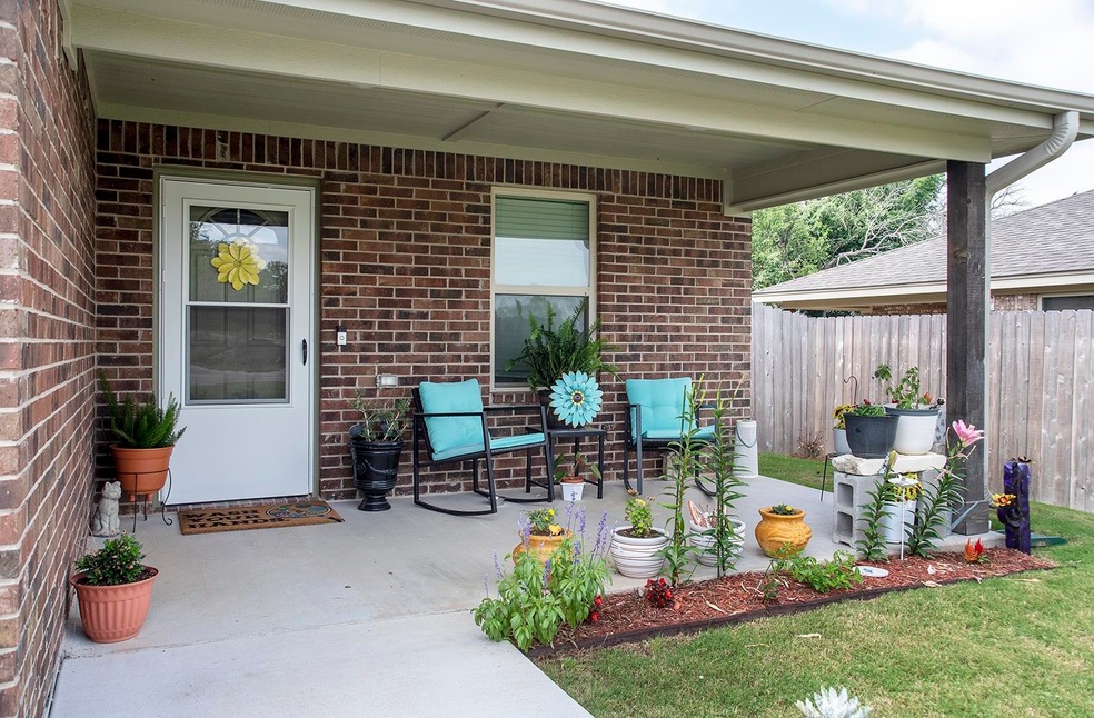 An adorable covered front porch with storm door greets you at the entry.