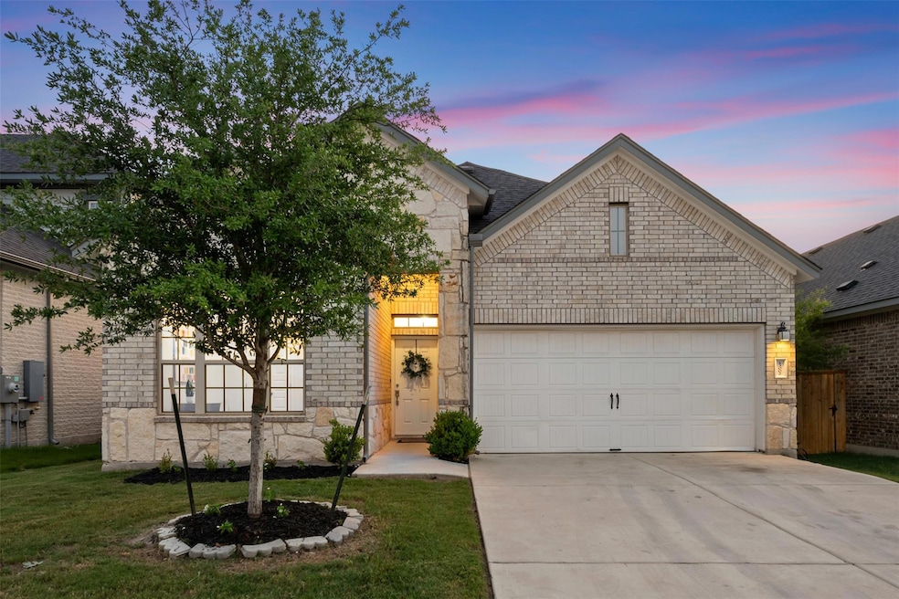 View of front facade featuring stone siding, an a
