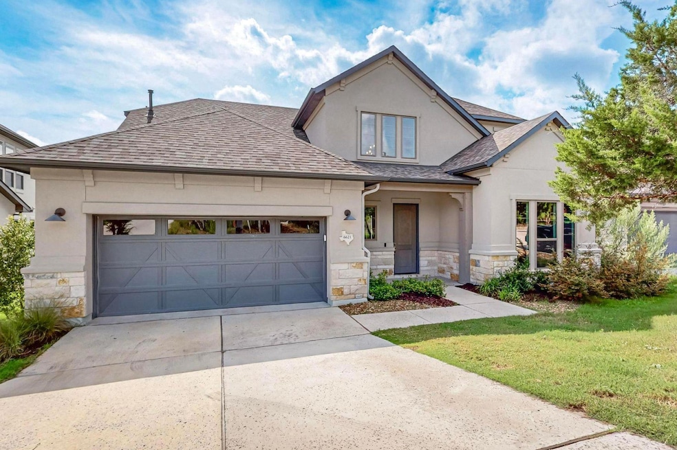 View of front of home featuring a garage, a shing