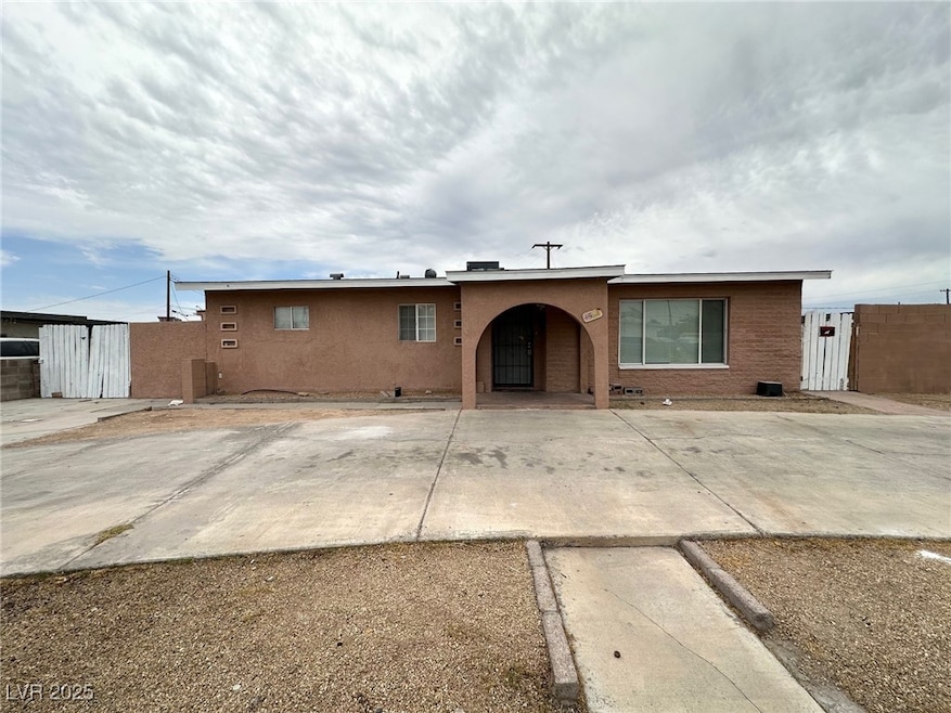 Single story home featuring stucco siding and a gate