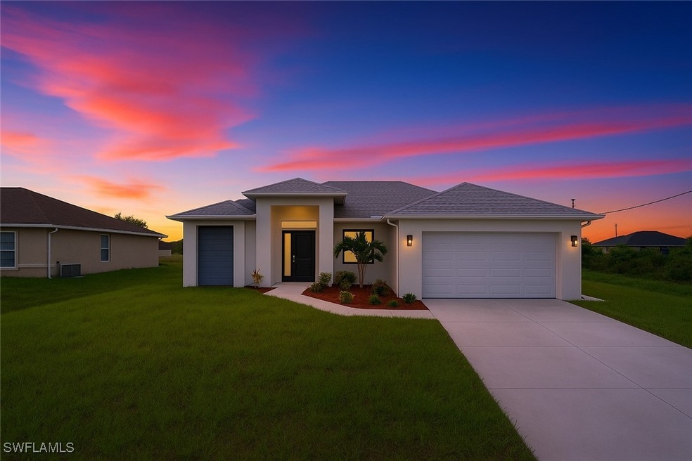 Prairie-style home with a garage, driveway, a yard