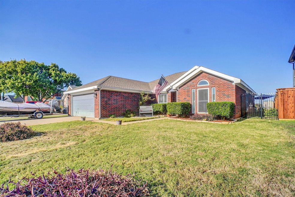 Ranch-style house featuring brick siding, concrete driveway, an attached garage, and roof with shingles