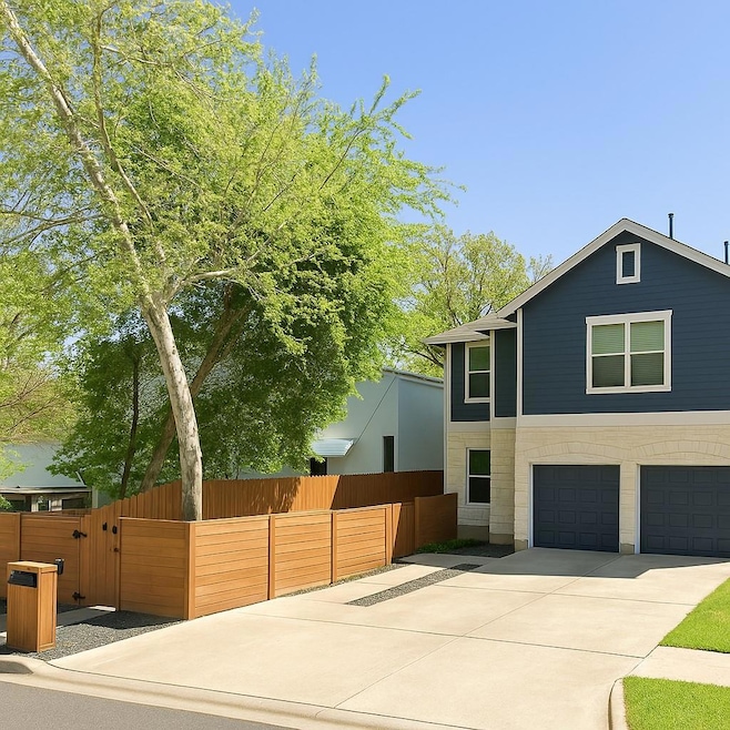 View of front facade with a garage, driveway, and
