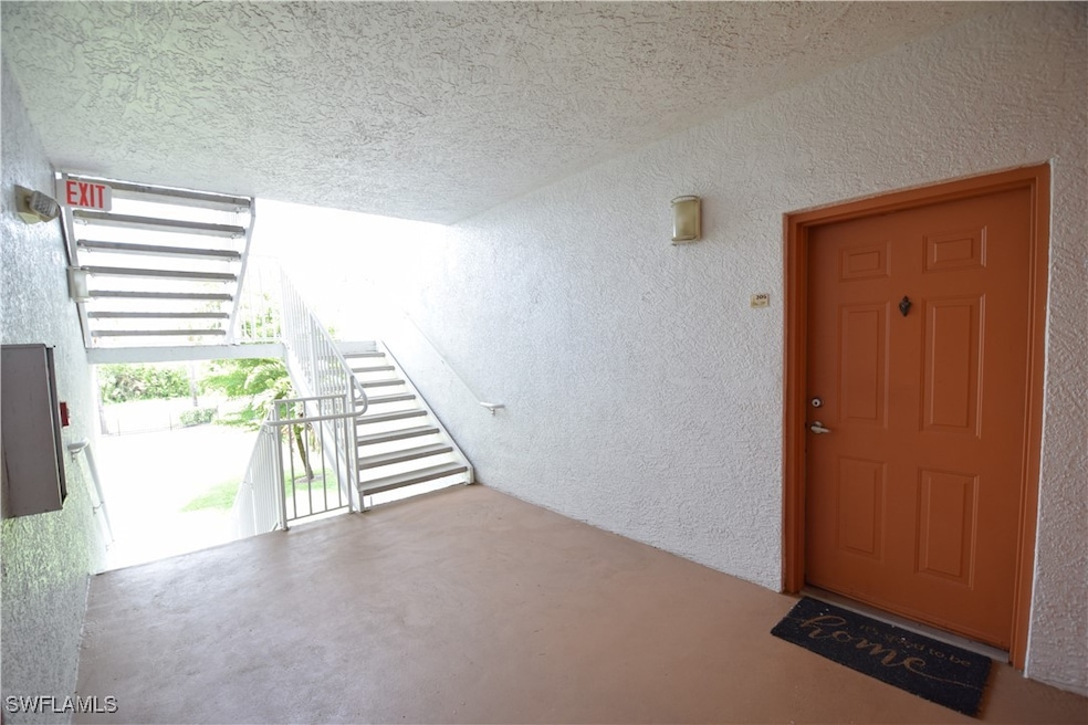 Entrance to property with stucco siding
