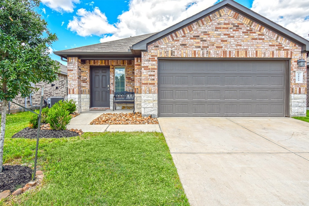 This is a modern, single-story brick home with a t