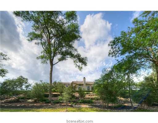Exterior Front. Exquisite custom home in Pebble Creek overlooking hole #5 of the Pebble Creek Golf Course.