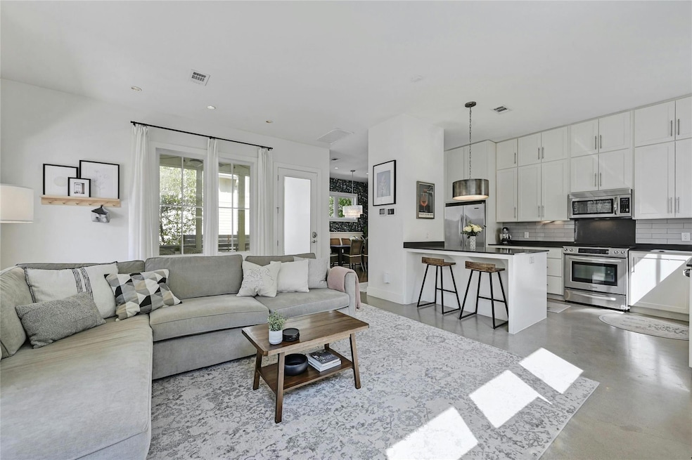 Living area featuring concrete flooring and visib