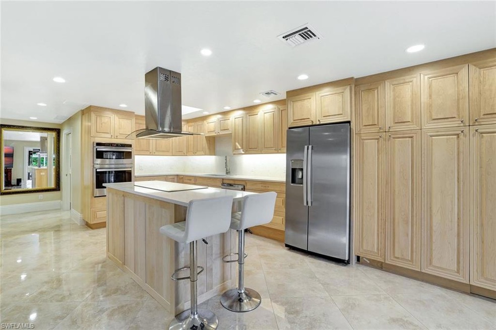 Kitchen with island range hood, a kitchen island, 