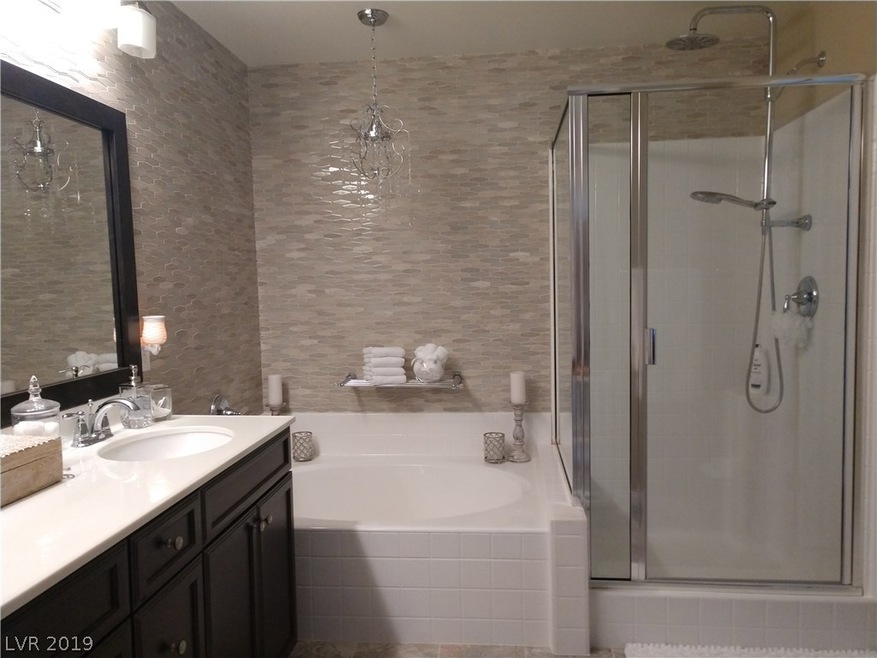 Stunning tile master bathroom with chandelier