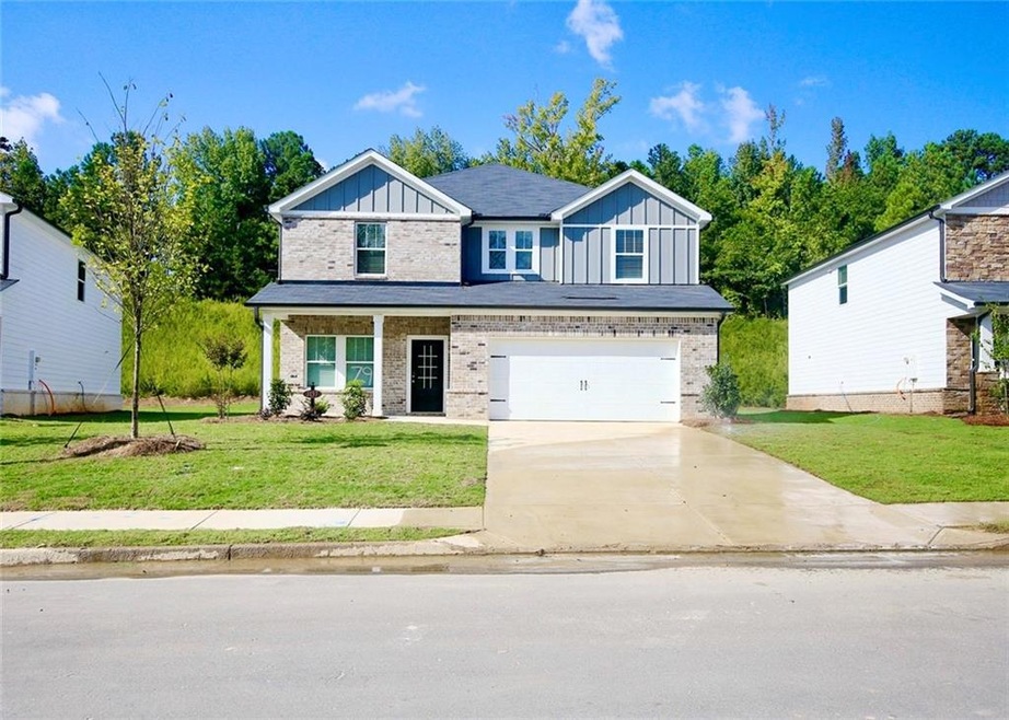 View of front facade with a front lawn and a garage