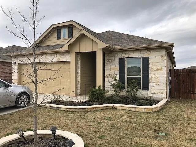 View of front of property featuring stone siding,