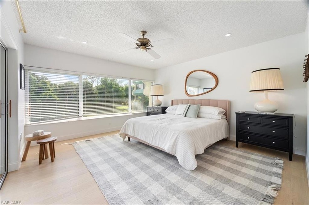 Bedroom with a textured ceiling, light wood finished floors, baseboards, ceiling fan, and recessed lighting