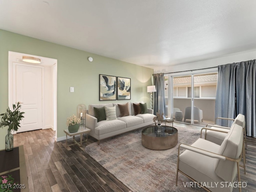 Living area with wood finished floors and baseboar