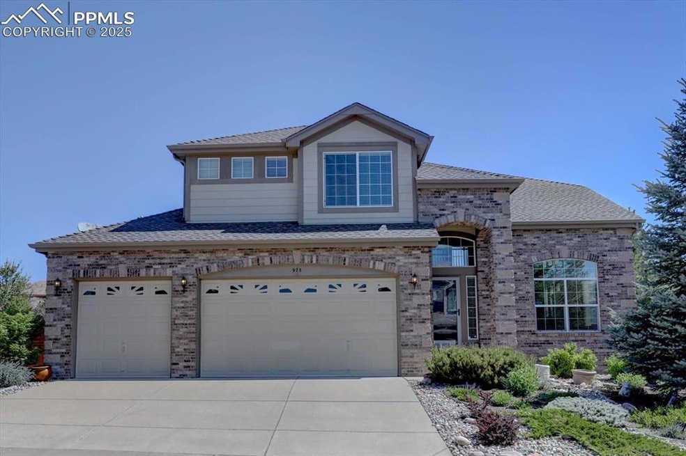 View of front of house featuring brick siding, concrete driveway, and a shingled roof
