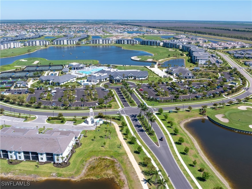 View of property location featuring a golf course and a nearby body of water