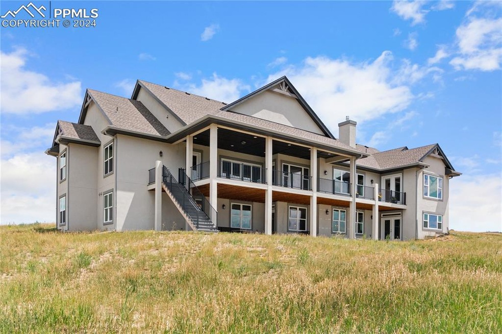 Back of house with a balcony