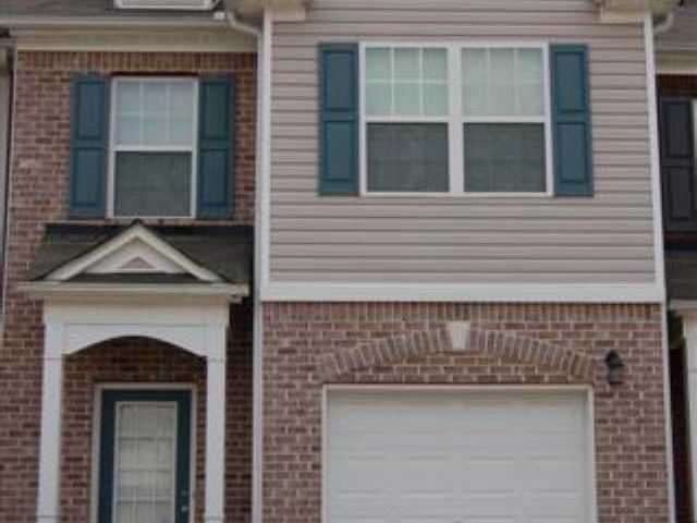 Exterior Front. Luxury Townhome with garage and hu