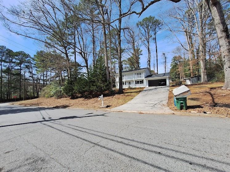 View of front of home featuring a garage and drive
