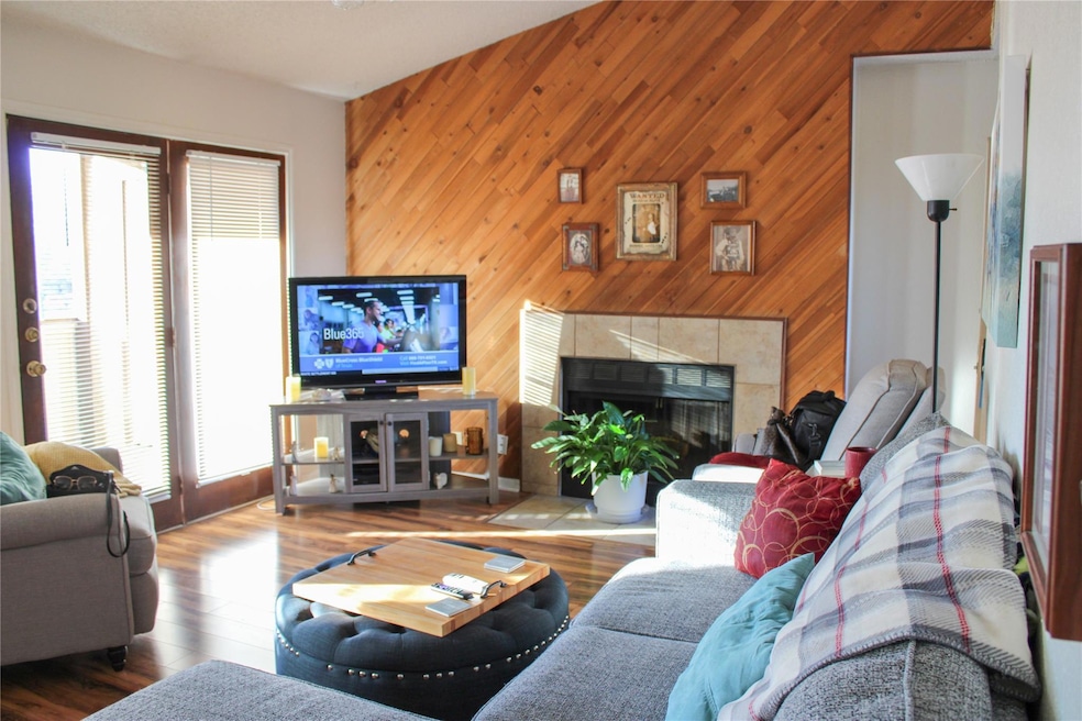 Living room with accent wood walls, vinyl wood flo