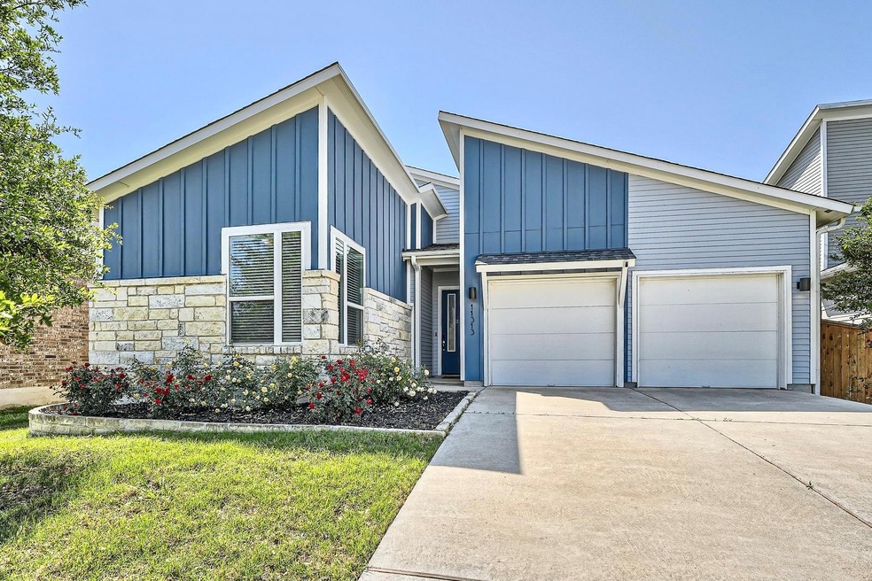View of front of home with an attached garage, bo