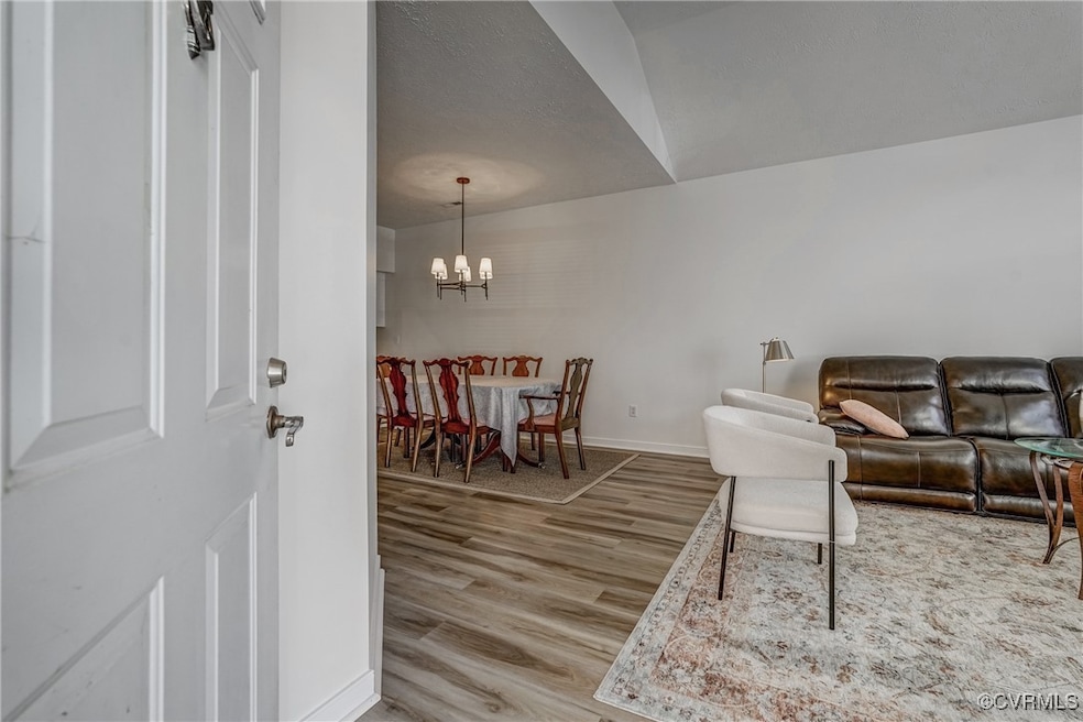 Living room with an inviting chandelier, wood fini