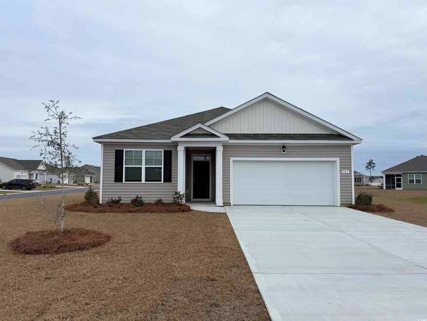 View of front facade with a garage and a front law