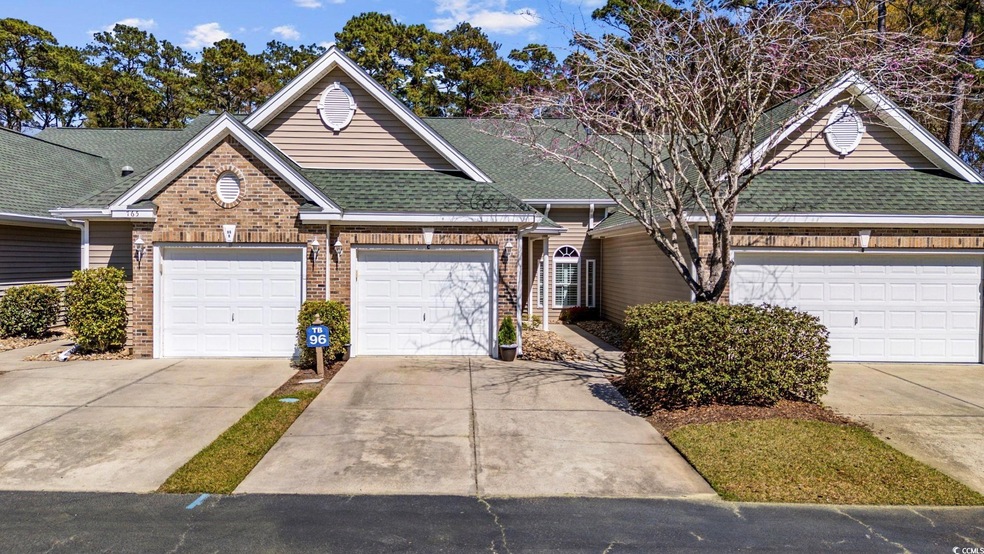 View of front of property with a garage, brick sid