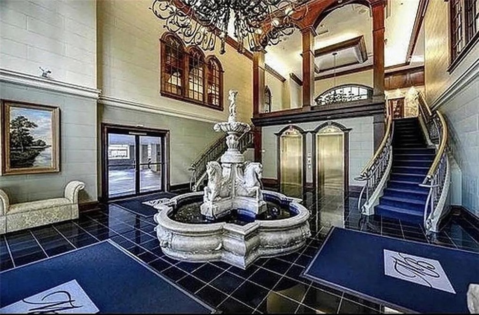 Lobby featuring a towering ceiling and stairs