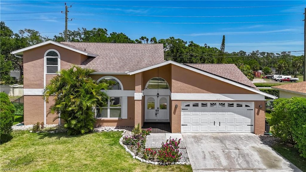 Mid-century home featuring stucco siding, an attac