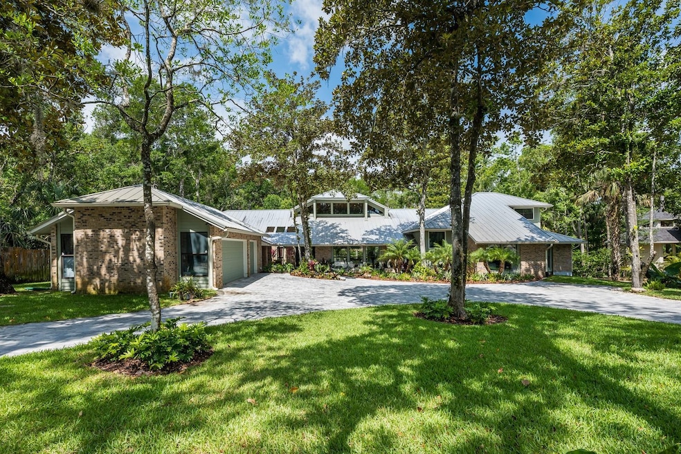 Tucked away at the end of a quiet CUL-DE-SAC in the desirable Trails community of Ormond Beach, this extraordinary CUSTOM WATERFRONT ESTATE sits on 1.31 ACRES surrounded by mature trees with a SCREENED POOL/SPA and PRIVATE DOCK on the TOMOKA RIVER, offering unmatched privacy in a tranquil setting!