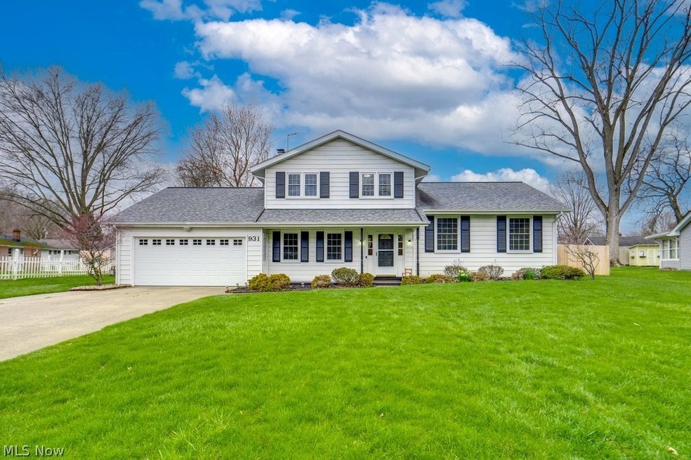 View of front of home featuring a front yard and a garage