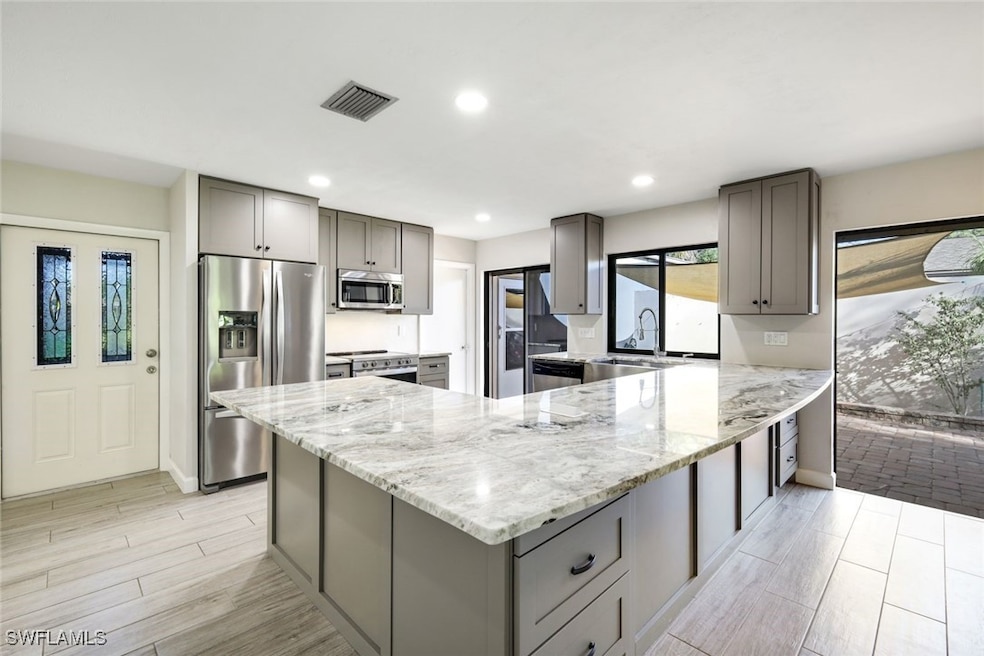 This totally remodeled kitchen opens up to the ent