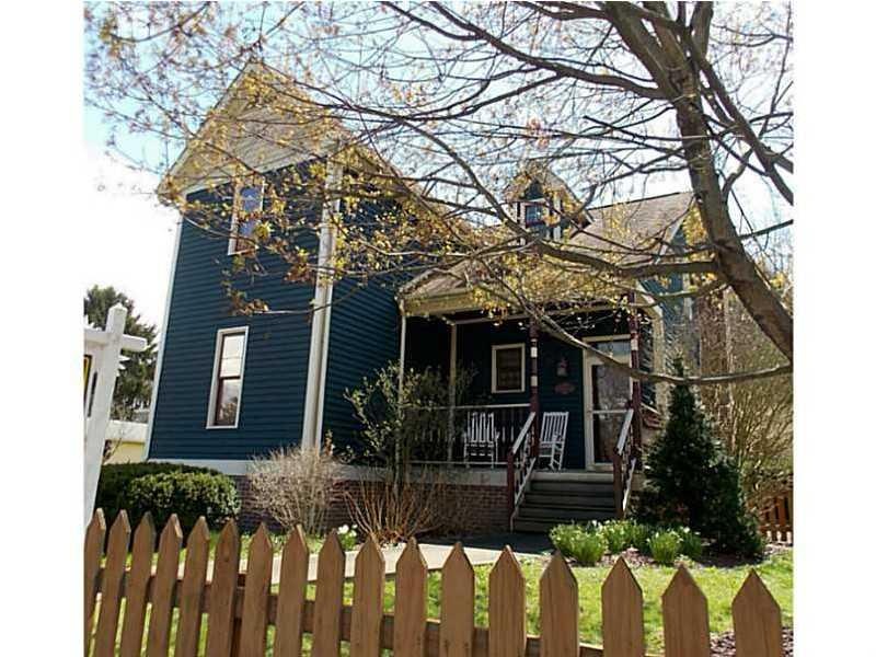 A real picket fenced doll house in the charming to
