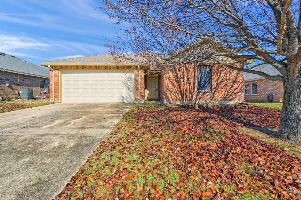 Ranch-style home featuring central AC and a garage