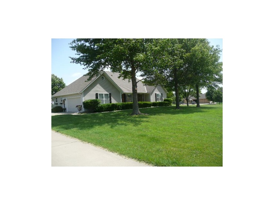 Front elevation.  Mature trees accent the attracti