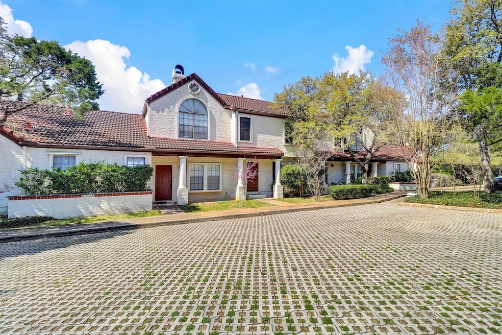 View of front of home featuring a tile roof, a ch