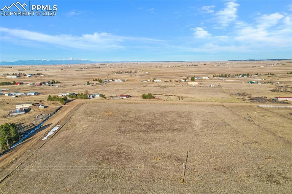 Birds eye view of property with a rural view