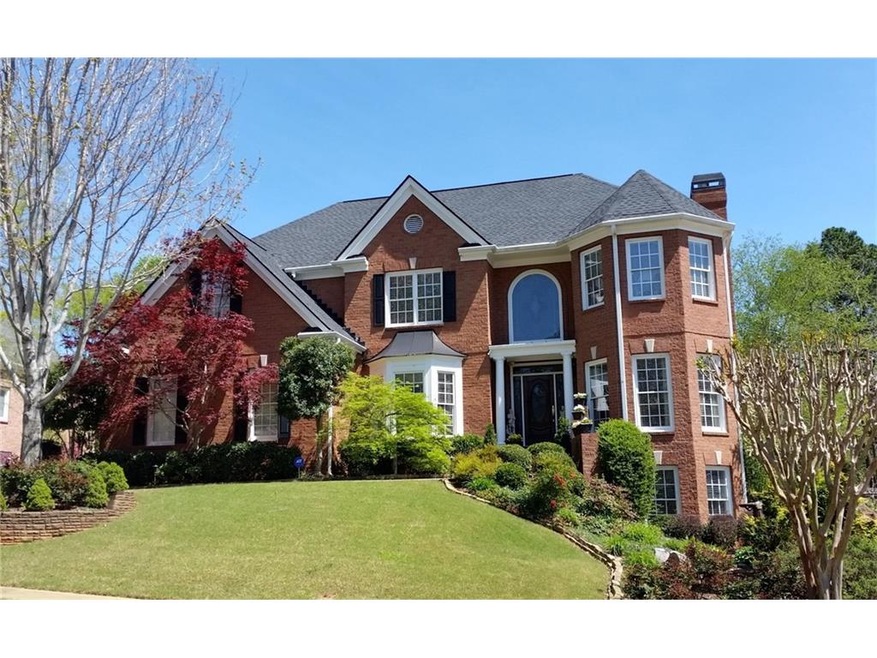 Stately 3-side brick home with three floor bay win
