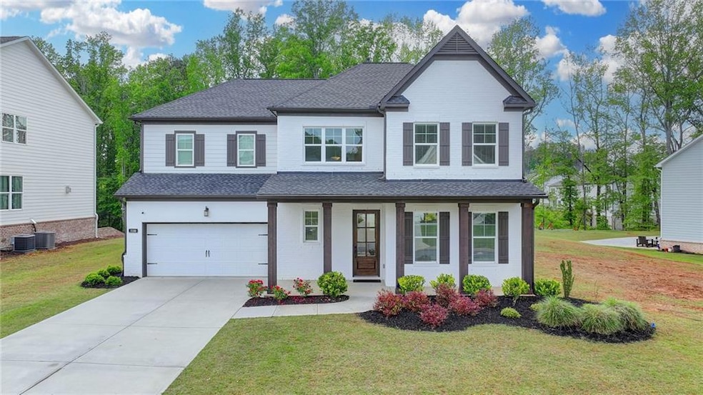 View of front of home with an attached garage, a s