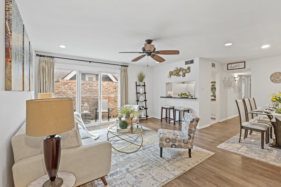 The living room looks into the kitchen and makes f