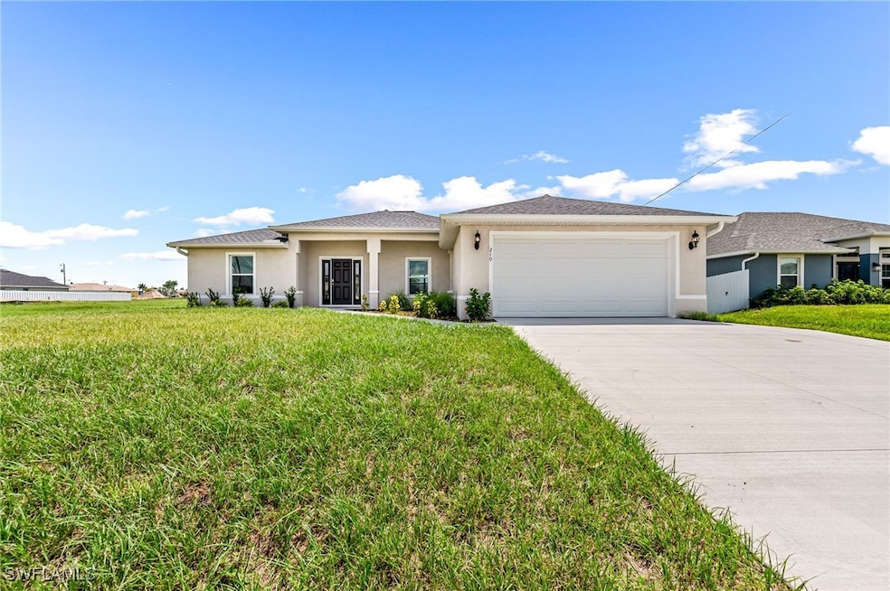 Prairie-style house with driveway, a front yard, a