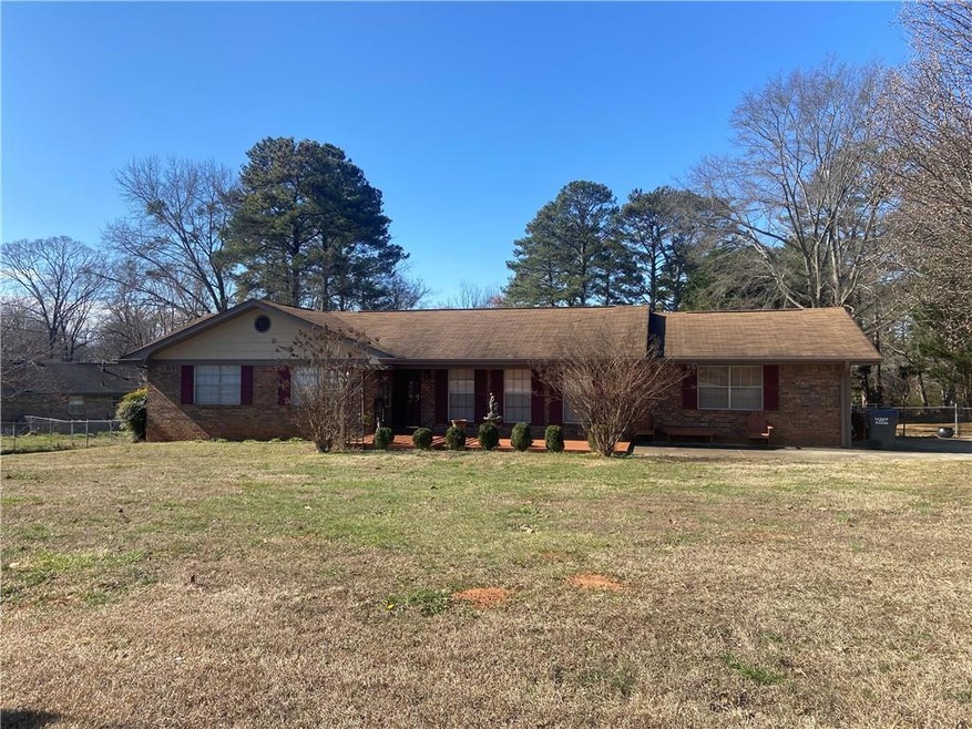 Ranch-style home featuring a front lawn and brick 